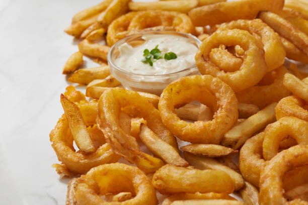 French Fries and Onion Rings Frings - French Fries and Onion Rings with Creamy Ranch Dip fried onion rings stock pictures, royalty-free photos & images