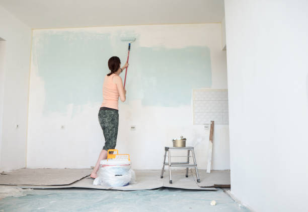 istock Woman painting wall 1468321157