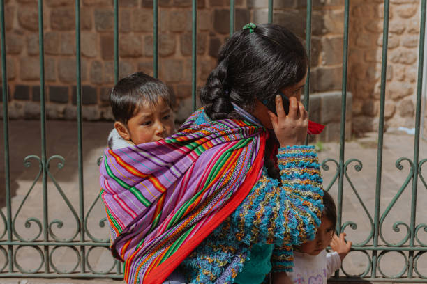 A mother on the phone with her children in Cusco
