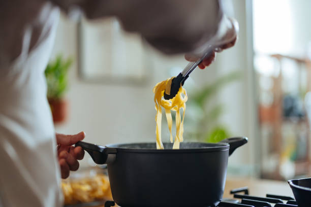 istock Unrecognizable Man Cooking Pasta In The Kitchen 1468322937