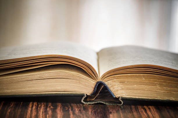 Book or textbook open old, black cover, close-up, selective focus