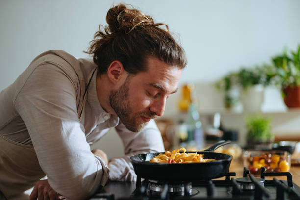 istock Happy Chef Smelling Pasta With Fresh Vegetables 1468323602