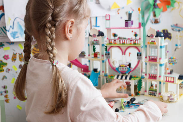 istock Little cute girl spending time in the playroom with a constructor 1468326631