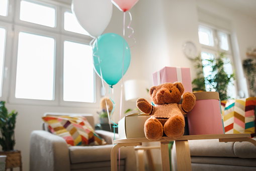 Room with gifts decorated for baby shower party with no people