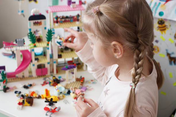 istock Little cute girl spending time in the playroom with a constructor 1468327775
