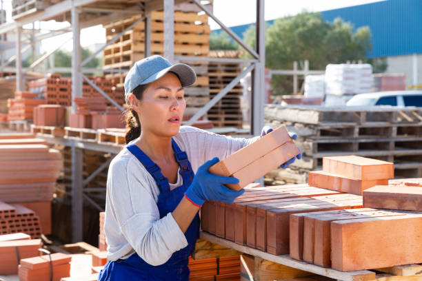istock Asian construction shop worker stacks bricks on an open-air site 1468329163