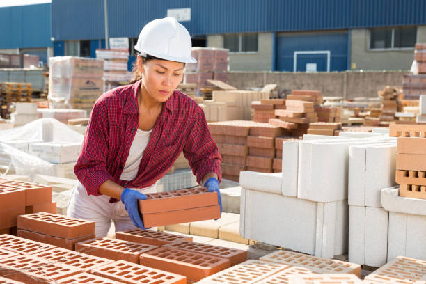 istock Attentive asian woman is laying bricks 1468329738