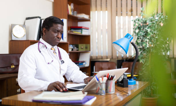 istock Focused african american doctor works at a computer in an office 1468329819