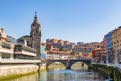 Buildings, church and a bridge in the Bilbao estuary