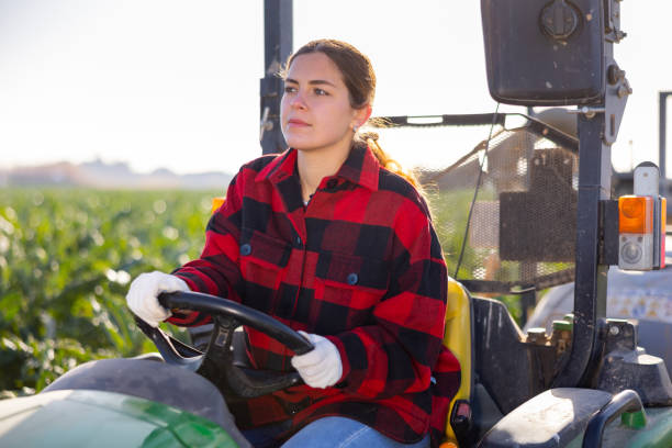 istock Woman farmer working on farm tractor 1468331334