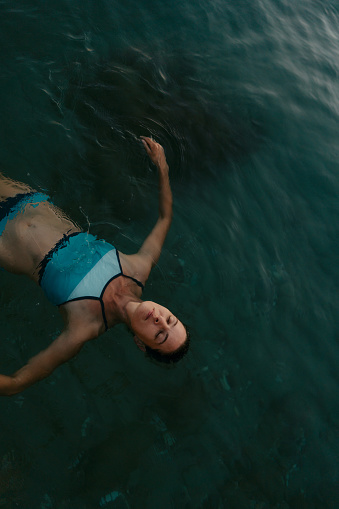 Photo of a mid-adult woman swimming in the sea