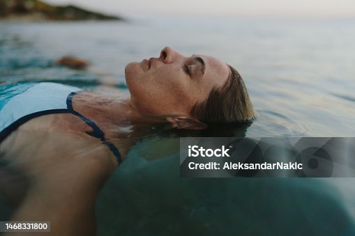 istock Mid-adult woman swimming in the sea 1468331800