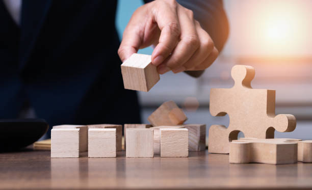 istock The businessman setting up a wooden cube with space for writing letters to plan the work, business concept 1468333117