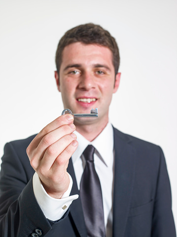 Corporate male handing you a key