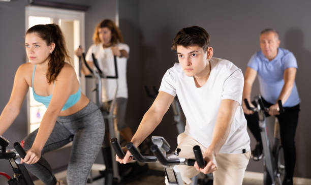 istock Young guy doing cardio workout on exercise bike in gym 1468333396
