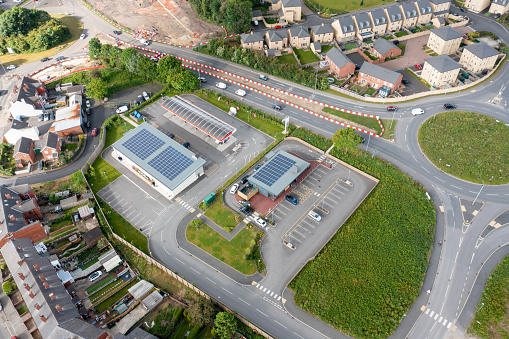 Aerial photo of a petrol station in the UK, showing solar panels on the roof. taken in the town of Wakef