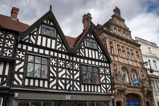 Shrewsbury, Shropshire, England - 28 July 2015. Timber frame Elizabethan era buildings in Shrewsbury, Shropshire, England. A cloudy day in summer in the historic, medieval town of Shrewsbury, Shropshire on the border with north Wales. View from below and looking up to the picturesque upper floors of the building.
