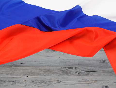 Close up of the Russian Federation flag with wooden background and copy space