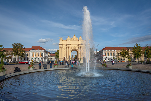 Potsdam, Germany - Sep 13, 2019: Brandenburg Gate (Brandenburger Tor) and fountain at Luisenplatz Square - Potsdam, Brandenburg, Germany