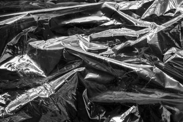 istock transparent plastic bag film wrap overlay texture on black background 1468346071