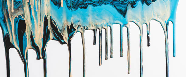istock Liquid ink flows down white canvas. Fluid art background with mix of light blue and golden tints. Acrylic paints flows to down. Cyan gold abstract backdrop. Mixing of glitter colors. Aqua with gilding 1468346549