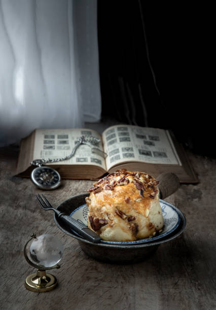 istock Caramel Pecanbon topped with caramel frosting and pecans served with Metal fork on old rustic wooden background. 1468347555
