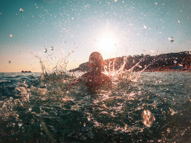 istock Sunset Fun, Young Kid Playing by the Beach 1468348229