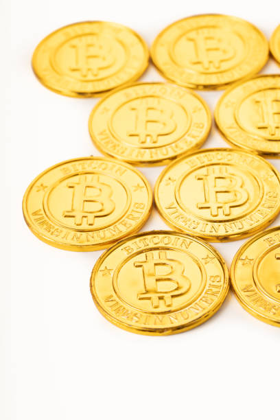 A pile of golden bitcoins placed together stock photo