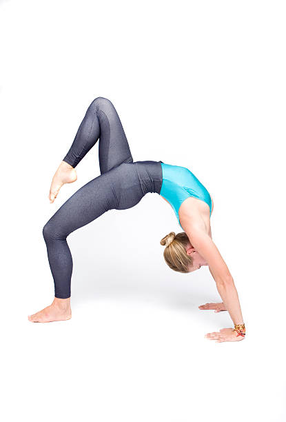 young woman in acrobatic pose stock photo