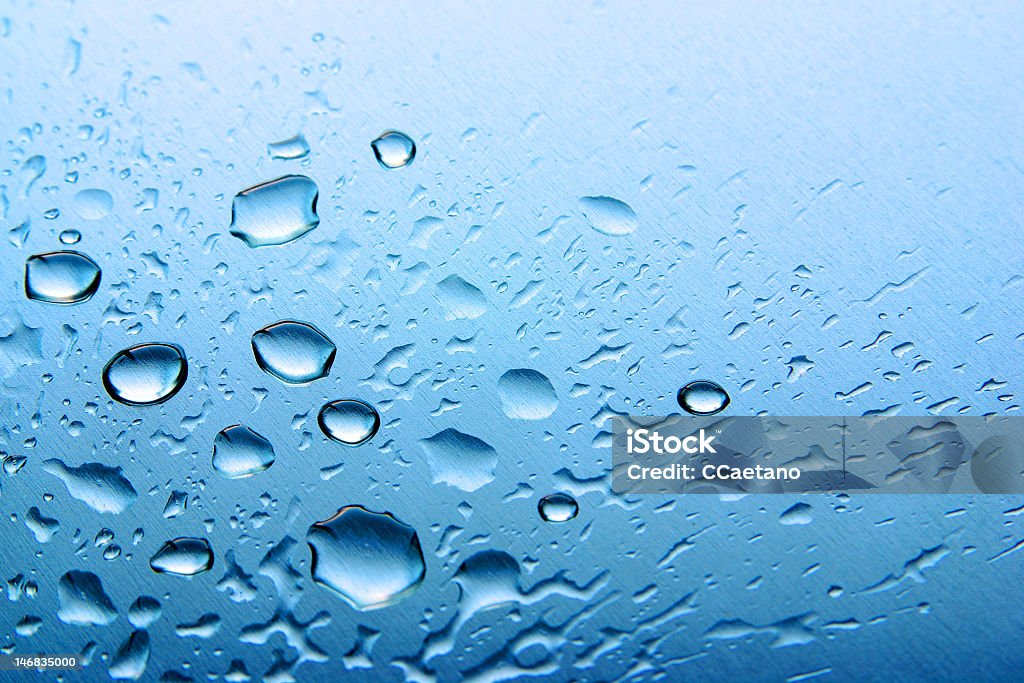 Drops on Blue Pattern of water drops in a shining metallic surface Abstract Stock Photo