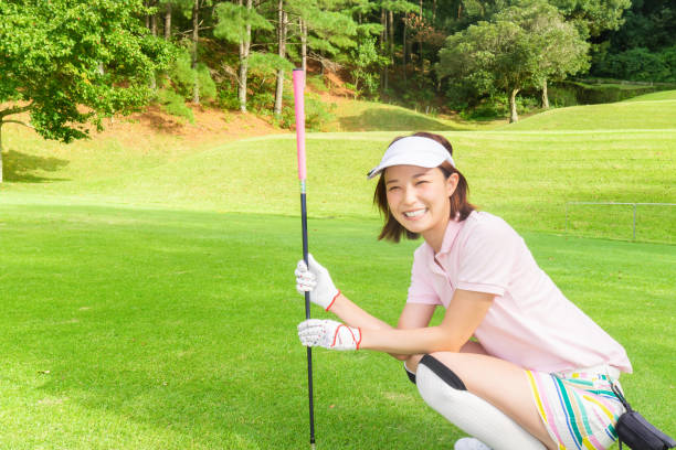 Beautiful young asian woman play golf