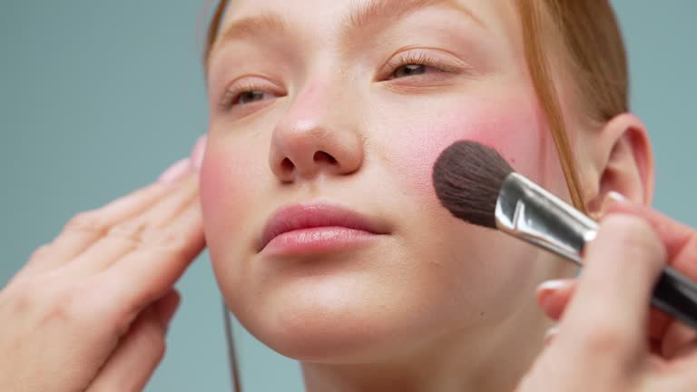 Makeup artist applying blush