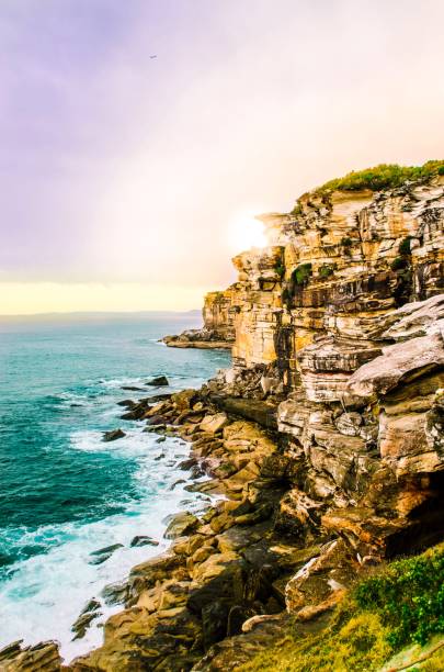 istock Serene Sunrise over the Pacific: Majestic Cliffside and Ocean Waves 1468351514