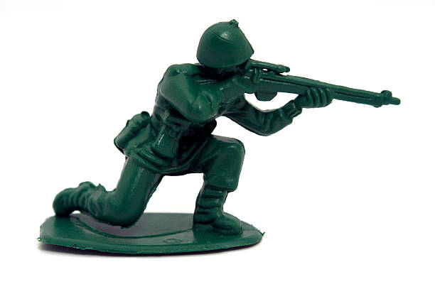 Toy Army Gunner A toy army soldier holding a rifle. The soldier is isolated on a white background. guerrilla warfare photos stock pictures, royalty-free photos & images