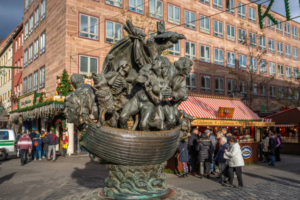 Copenhagen, Denmark - August 25th, 2013. A group of people gatered around fountain on Kultorvet in Copenhagen, a child is playing in the water fountains.