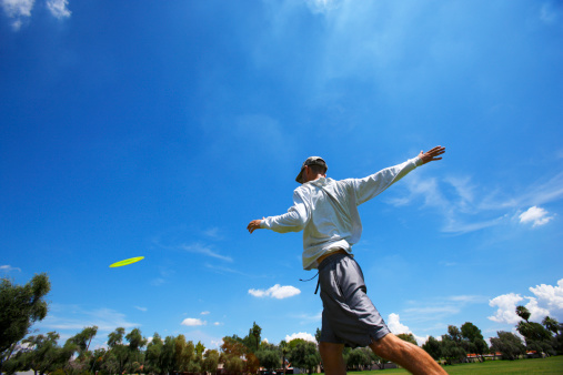 Disk golf player showing throwing form.