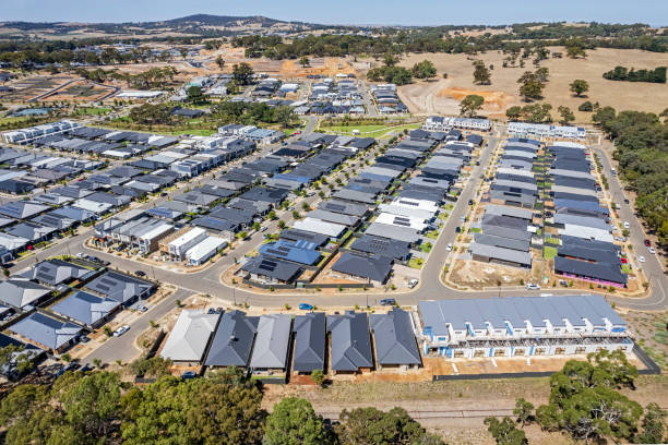 istock Aerial view urban sprawl with new housing developments, railway line, rolling hills. 1468356580