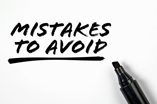 Mistakes To Avoid. Text and black marker on a white background.