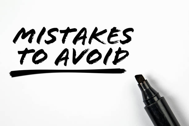 Mistakes To Avoid. Text and black marker on a white background stock photo