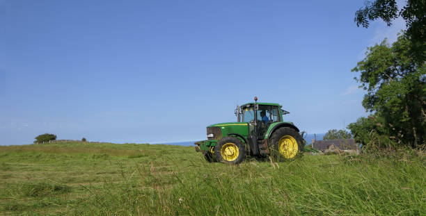 John Deere 6920 Tractor and Mower cutting Grass for Silage on a Farm in UK