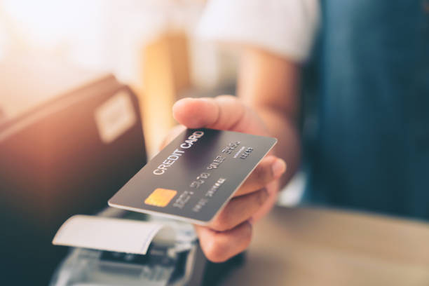 istock Customer holding credit card for payment on card reader machine to owner at restaurant. 1468360822
