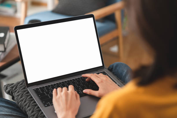 Woman hand type a message on the keyboard on laptop with blank copy space screen, mock-up for the application. stock photo