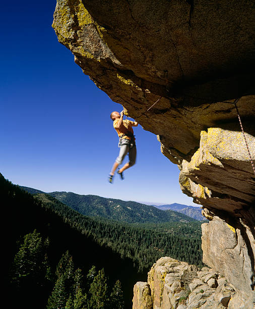 istock Male rock climber clinging to an overhang. 146836204