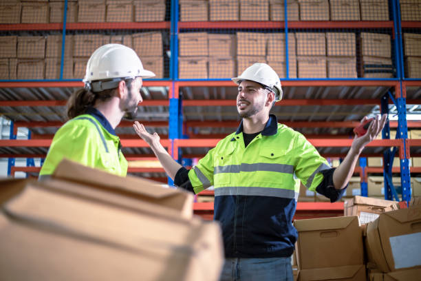 istock Professional supervisor talking about job with worker in warehouse 1468364140
