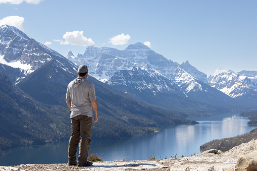 Young Man Looking At The View While Hiking at Bear's Hump Trail in Waterton Lakes National Park, Alberta, Canada