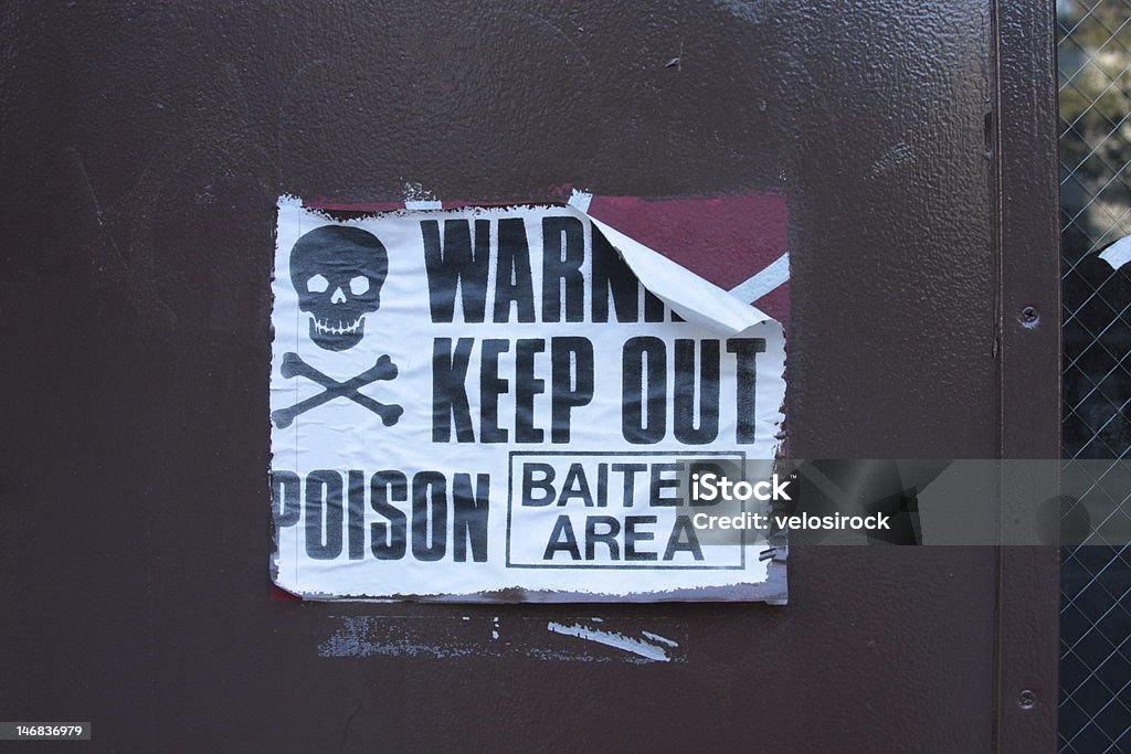 Paper "Warning" sign- poison Paper "Warning" sign, peeling off on one corner. Rat Stock Photo