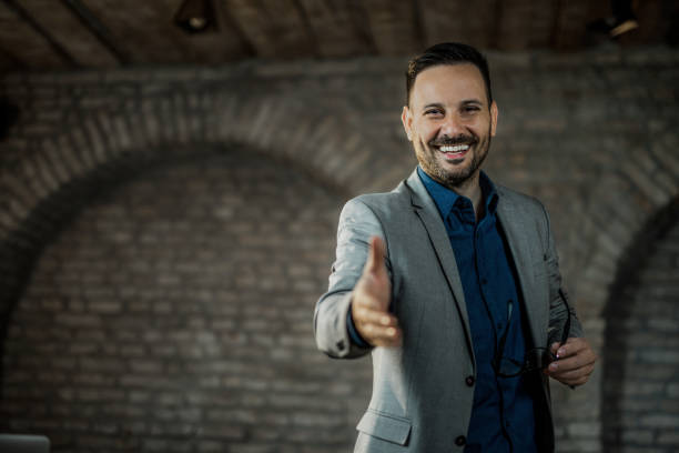 istock Front view of young businessman shaking hands in the office. 1468369983