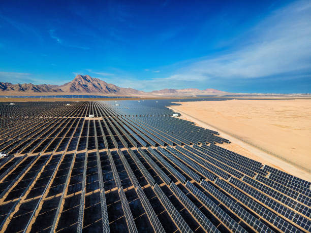 Solar Panel Array Farm in Desert Area South of Boulder City Nevada on a Sunny Day with Sloan Canyon National Conservation Area and North McCullough Mountains stock photo