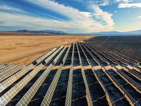 Solar Panel Array Farm in Desert Area South of Boulder City Nevada on a Sunny Day with Sloan Canyon National Conservation Area and North McCullough Mountains in the Distance