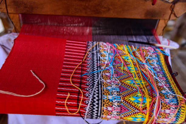 istock Traditional woven fabric Mae Chaem pattern that has not finished weaving in the loom at Mae Chaem District, Chiang Mai Province, Thailand 1468371765